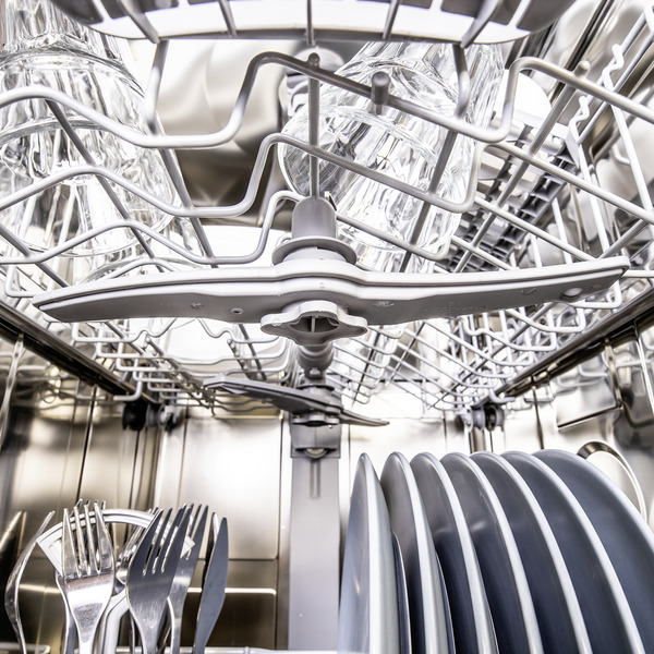 Inside view of a loaded dishwasher with clean dishes Inside view of a loaded dishwasher with clean dishes